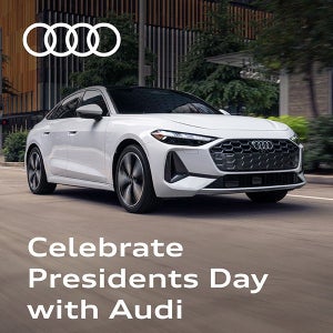 View of passenger side of white Audi A5 driving